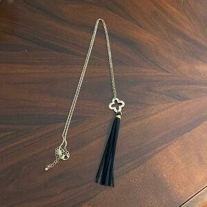 Gold necklace with black tassel